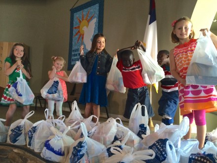 Fountains kids with just a few of the many bags already collected for the 9/11 Multi-Faith food drive